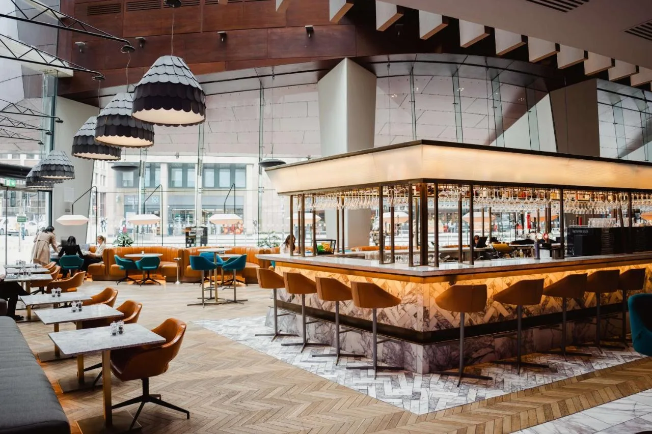 Hotel bar with tables and chairs at Radisson Blu Hotel, Glasgow